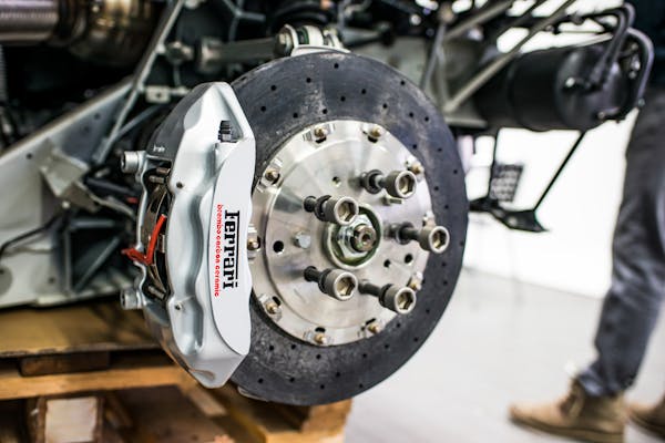 Brake rotor and caliper on a vehicle in a repair shop